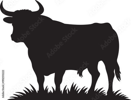 Strong silhouette of longhorn standing on grass, symbolizing Texas heritage