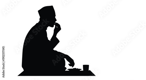 A contemplative man enjoying a meal presented as a silhouette
