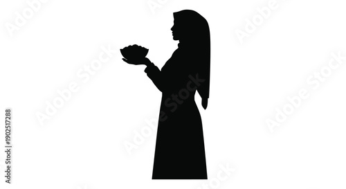 A veiled woman holding flowers in a striking black silhouette
