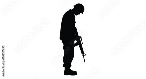A somber soldier stands with head bowed a powerful silhouette