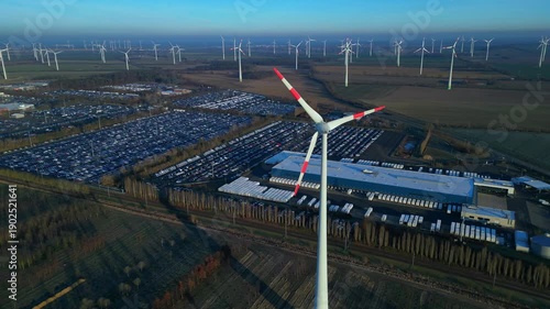 speed ramp Wind turbines near car logistics storage. Great aerial view drone