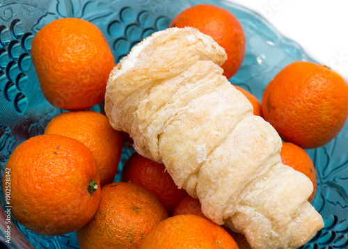 Canvas Print Tangerines and cakes in a vase.