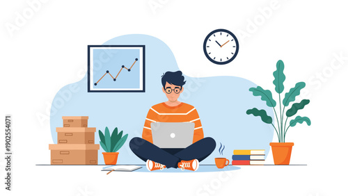 Focused young man sitting on the floor with his laptop working from home in a cozy room with plants books and a productivity chart.