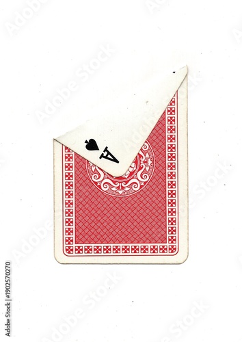 The back of a vintage playing card with one corner turned over isolated on a white background.