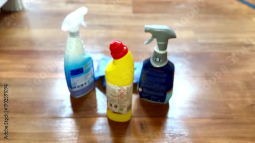 person putting on yellow rubber gloves about to start cleaning with products