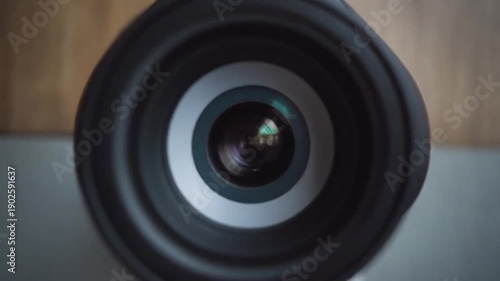 Surveillance camera capturing footage on a table against a wooden background