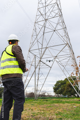 Professional worker using drone technology for power line infrastructure inspection