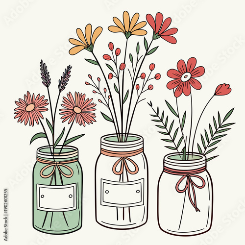 Colorful flowers in vintage mason jars with ribbons