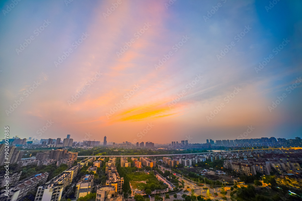 Fototapeta premium City Skyline Glowing at Dusk with Sunset Reflection