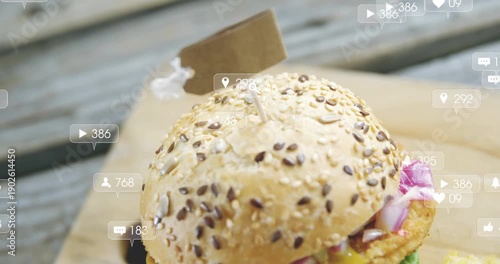 Camera pulling back revealing burger with fries, social icons floating, showing online engagement