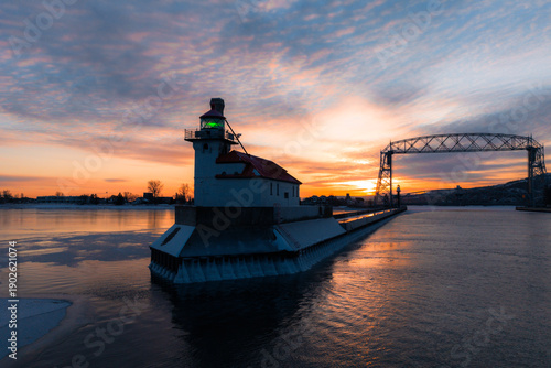 The Duluth North Pier Lighthouse stands amid thick sea smoke and rising steam on a frigid winter morning at the Duluth Ship Canal.