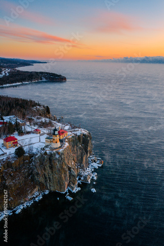Obraz na płótnie Drone photograph capturing Split Rock Lighthouse surrounded by thick sea smoke rising from Lake Superior during a sub-zero winter morning