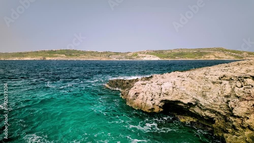 Ocean waves crashing on sandy beach in turquoise water