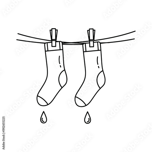 Two Socks Drying On Clothesline With Water Droplets Falling