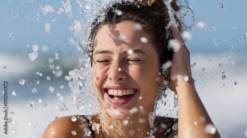 Young woman smiling joyfully while splashing in ocean water  