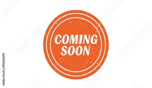 A bright orange coming soon stamp on a with a distressed texture