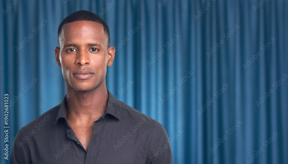 Fototapeta premium portrait of a man with a blue curtain backdrop