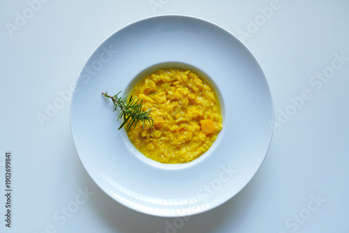 Overheard shot of Creamy pumpkin risotto on white background 
