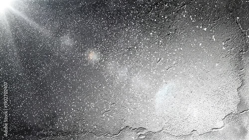 Grainy black and white abstract texture with sunlight effect