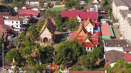 Wallpaper Mural Aerial moving scene of Buddhist temples, modern buildings and traffic in Vientiane, Laos capital cityscape during day Torontodigital.ca