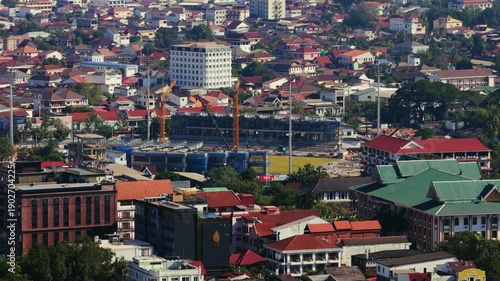 Wallpaper Mural Camera flying above Mekong river separating Laos and Thailand in the city of Vientiane, revealing buildings and urban development in Asia Torontodigital.ca