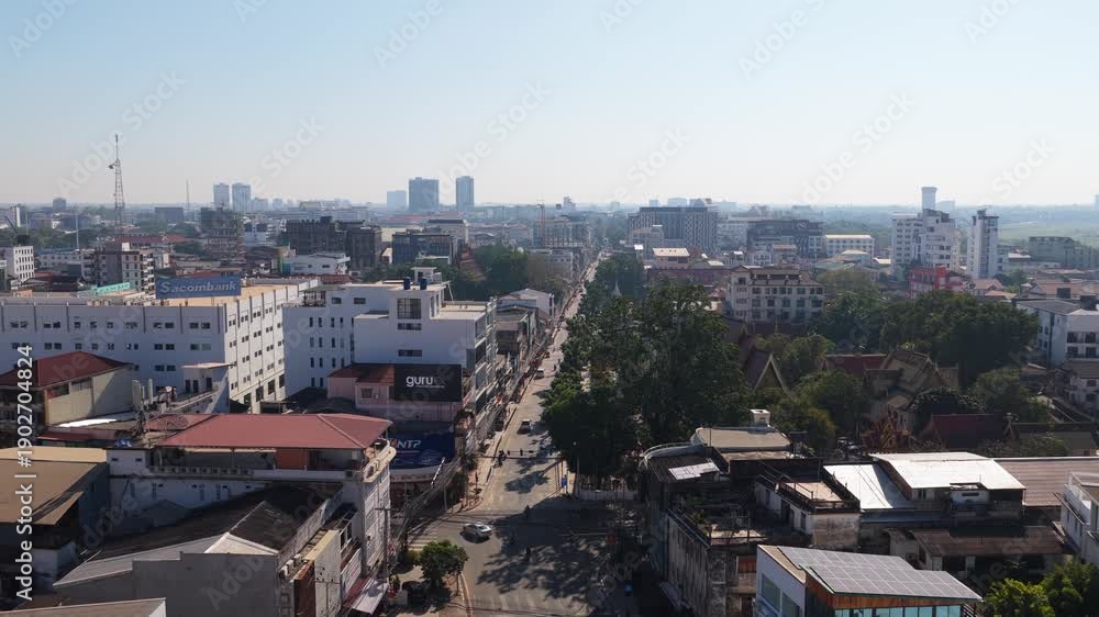 custom made wallpaper toronto digitalUrban landscape of Vientiane showing residential buildings, chaotic streets, and traffic with cars and busses in Laos capital city