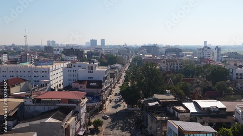 Wallpaper Mural Urban landscape of Vientiane showing residential buildings, chaotic streets, and traffic with cars and busses in Laos capital city Torontodigital.ca