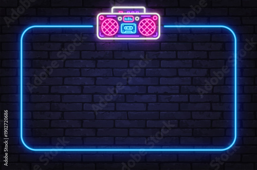 Neon boombox icon with glowing frame on brick wall. Retro music style brings urban night energy and creative mood.