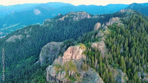 Mountain range of Rhodope Mountains covered with vegetation against the backdrop of valley covered with spruce forests