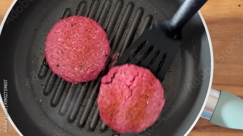Closeup of Flipping a Beef Hamburger Patty in a Frying Pan