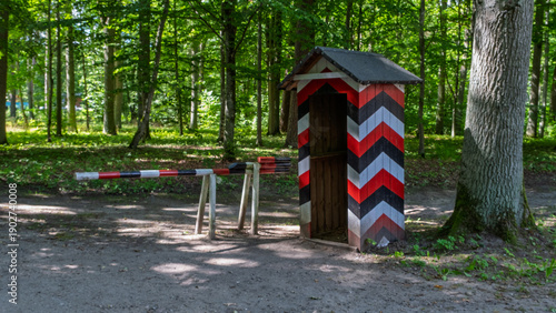 Painted military sentry box and road barrier