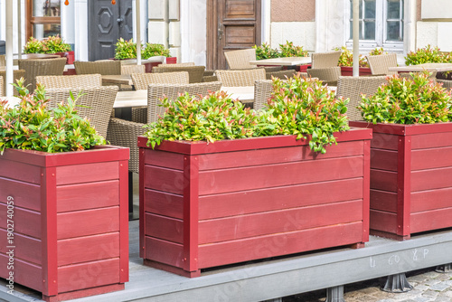 Outdoor cafe seating with red planter boxes