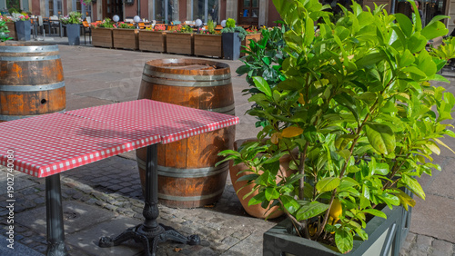 Cafe table with checkered tablecloth and barrels