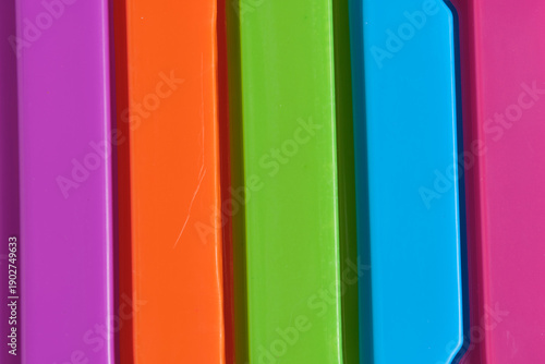Abstract macro background of colorful plastic surfaces and geometric lines.