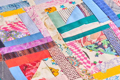 Colorful abstract patchwork background with diverse textile strips.