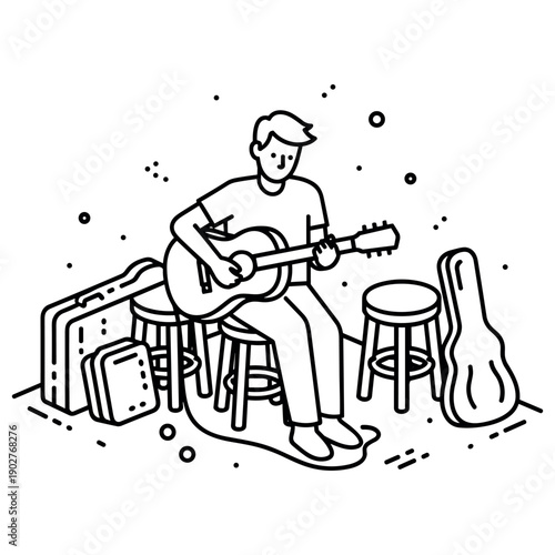 Young caucasian male playing acoustic guitar surrounded by musical equipment