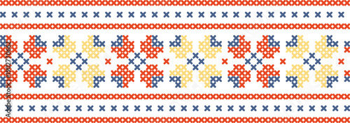 A colorful pattern of squares and crosses is embroidered on a white background