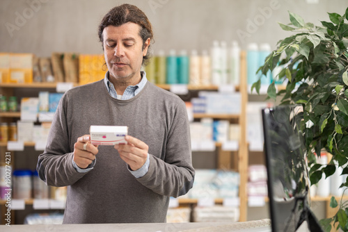 Male buyer buys paracetamol medicine at a pharmacy