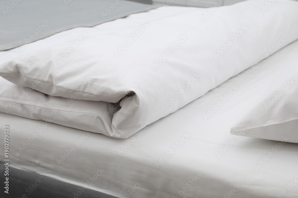 Fototapeta premium Comfortable bed with clean linens in bedroom, closeup