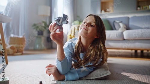 Carefree child playing lego apartment floor closeup. Girl building constructor 