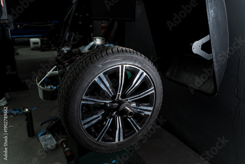 Canvas Print Seasonal tire replacement in professional workshop removing winter tires