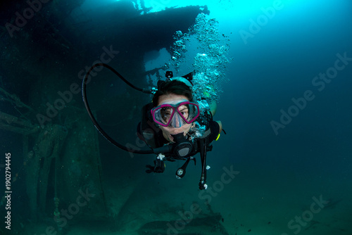 фотографія Woman scuba diving on shipwreck with reef fish, Colombo, Sri Lanka