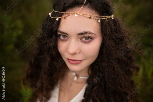 Beautiful Young Woman with Curly Hair in Summer Field at Golden Hour