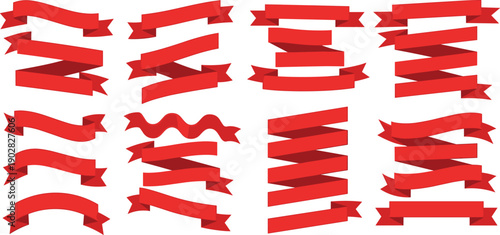 A collection of red ribbons arranged vertically in a repetitive pattern on a plain surface viewed from directly above