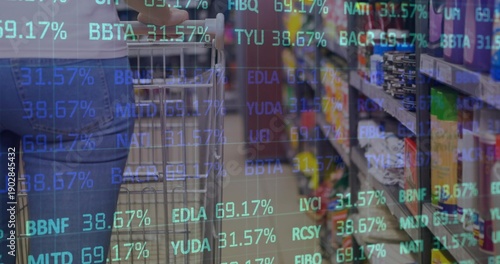 Pushing metal wire cart, shopper in denim jeans light top passing store aisle under ticker overlay