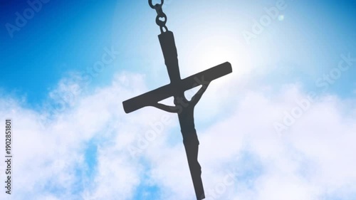 Dark cross pendant swinging while sun backlighting halo, clouds drifting, showing rough profile