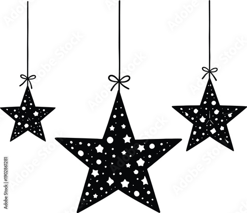 Three decorative hanging stars with intricate cutouts suspended by thin strings create a festive holiday silhouette.
