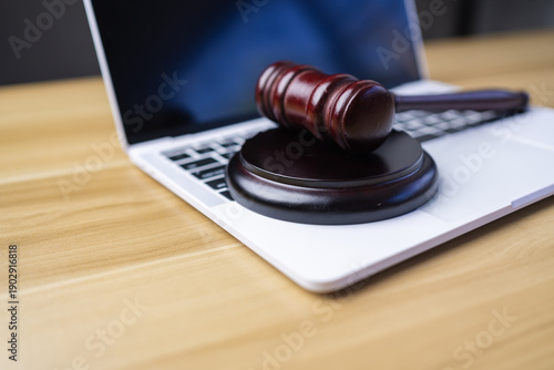  Judge gavel on laptop keyboard. Cyber law digital justice and online legal services