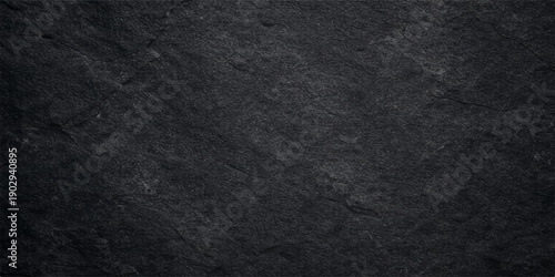 A dark, rough black asphalt texture provides a grunge stone surface pattern, creating an old macro backdrop with a gray material design suitable for a textile or paper wallpaper