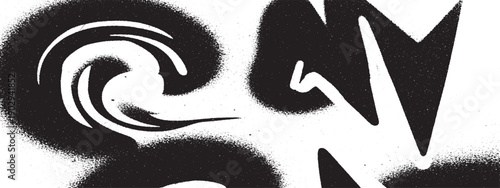 Abstract black and white spray paint graffiti art on a wall.